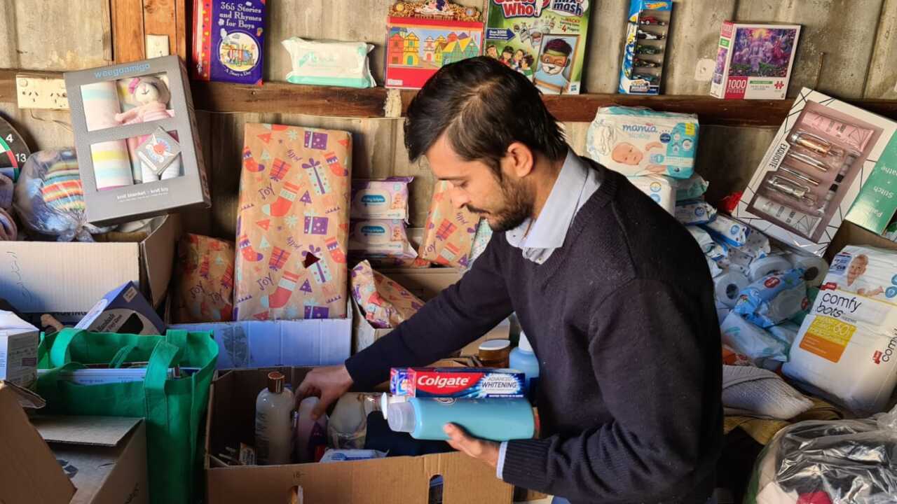 Mansoor Hashimi packing donations in his garage.