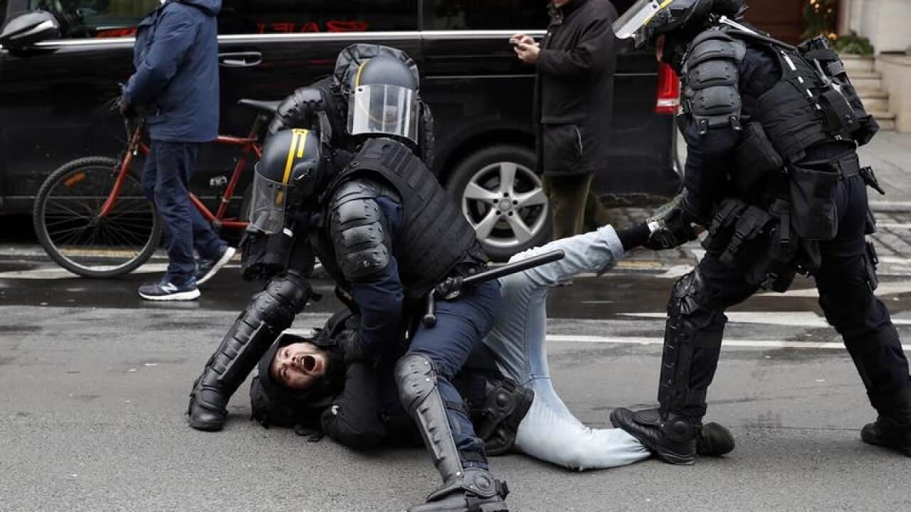 French police arrest a man during a Yellow Vests demonstration in Paris