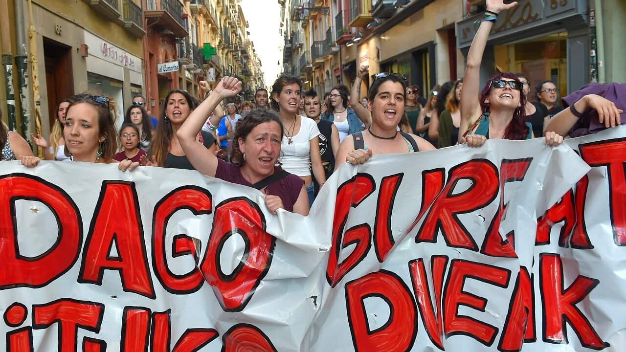 Protesters rally after a court ordered the release on bail of five men sentenced to nine years prison for sexually abusing a young woman in Spain.