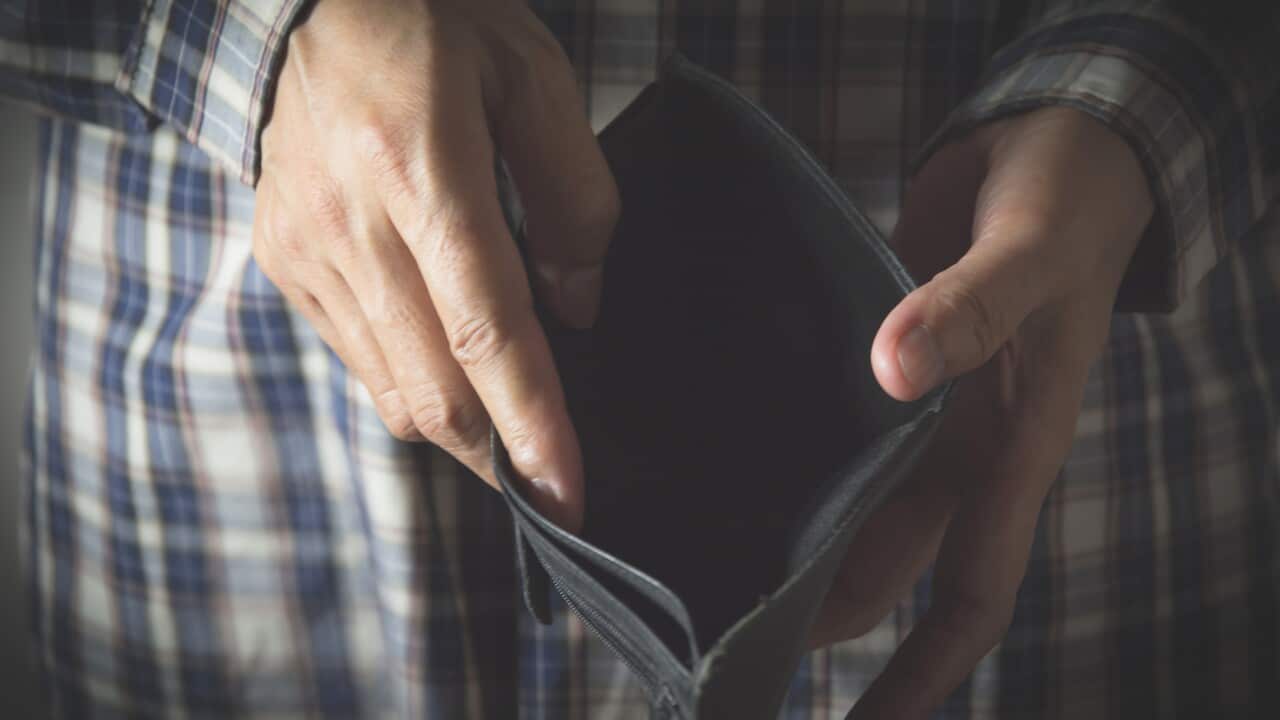 Midsection Of Man Holding Empty Wallet