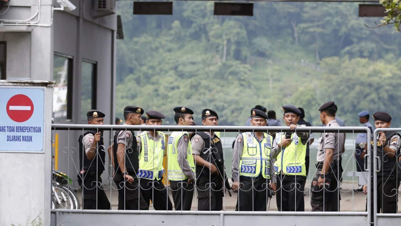 Police officers prepare for the transfer of death row prisoners