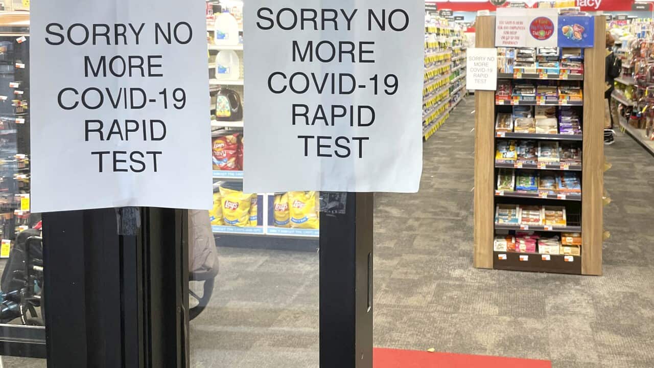 Signage in a shop window warning it has run out of rapid test stock.