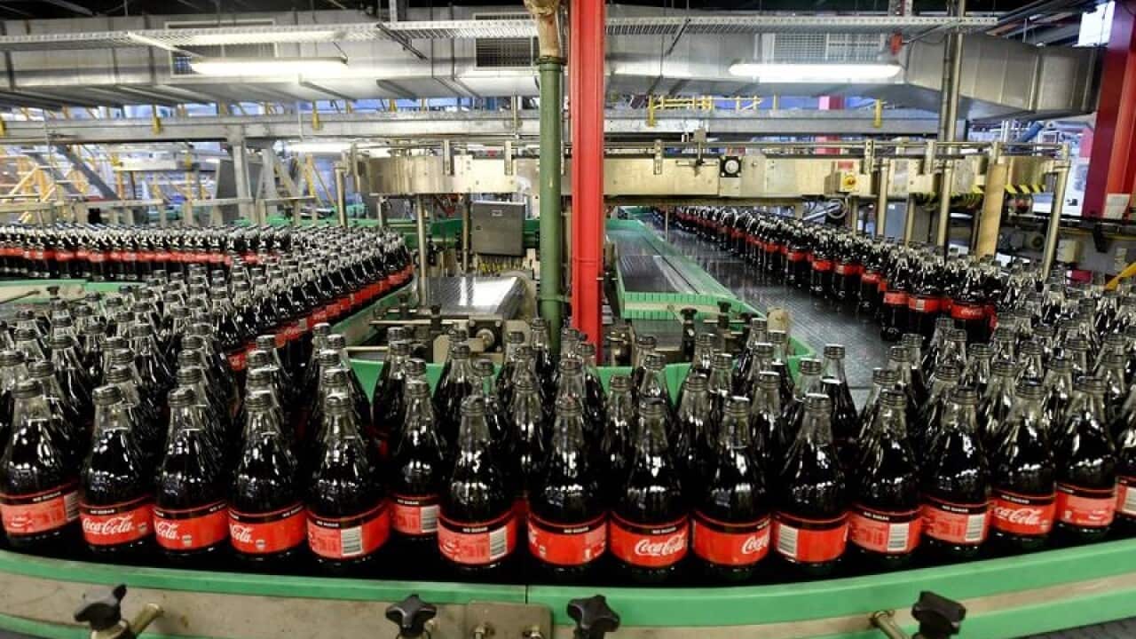 Bottles of Coca-Cola are seen on a production line