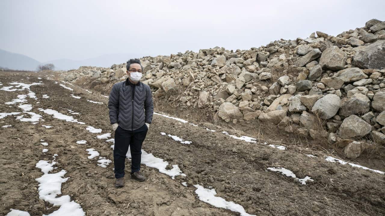 Han Gi-taek surveys farmland that he and his family helped clear of rocks for cultivation in Haean, South Korea.