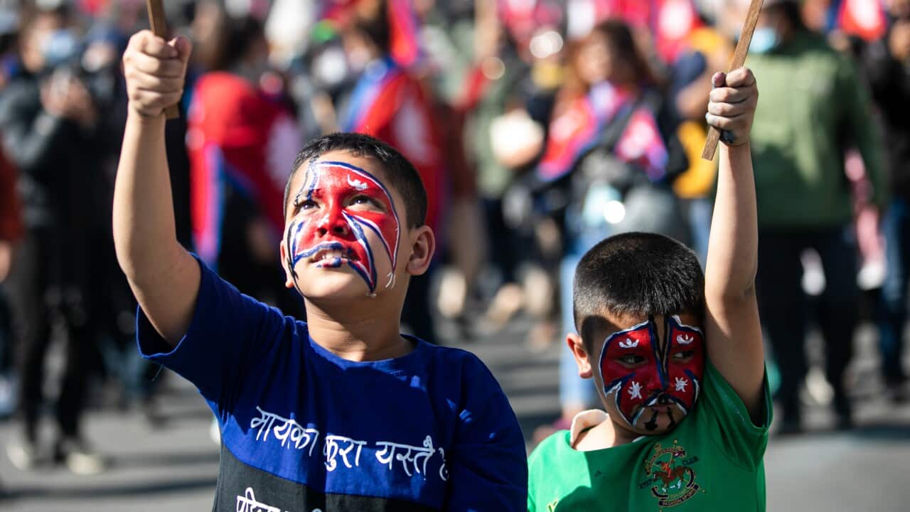 Nepalese boys with national flags painted on their faces seen during a pro-monarchy demonstration in Kathmandu, Nepal.