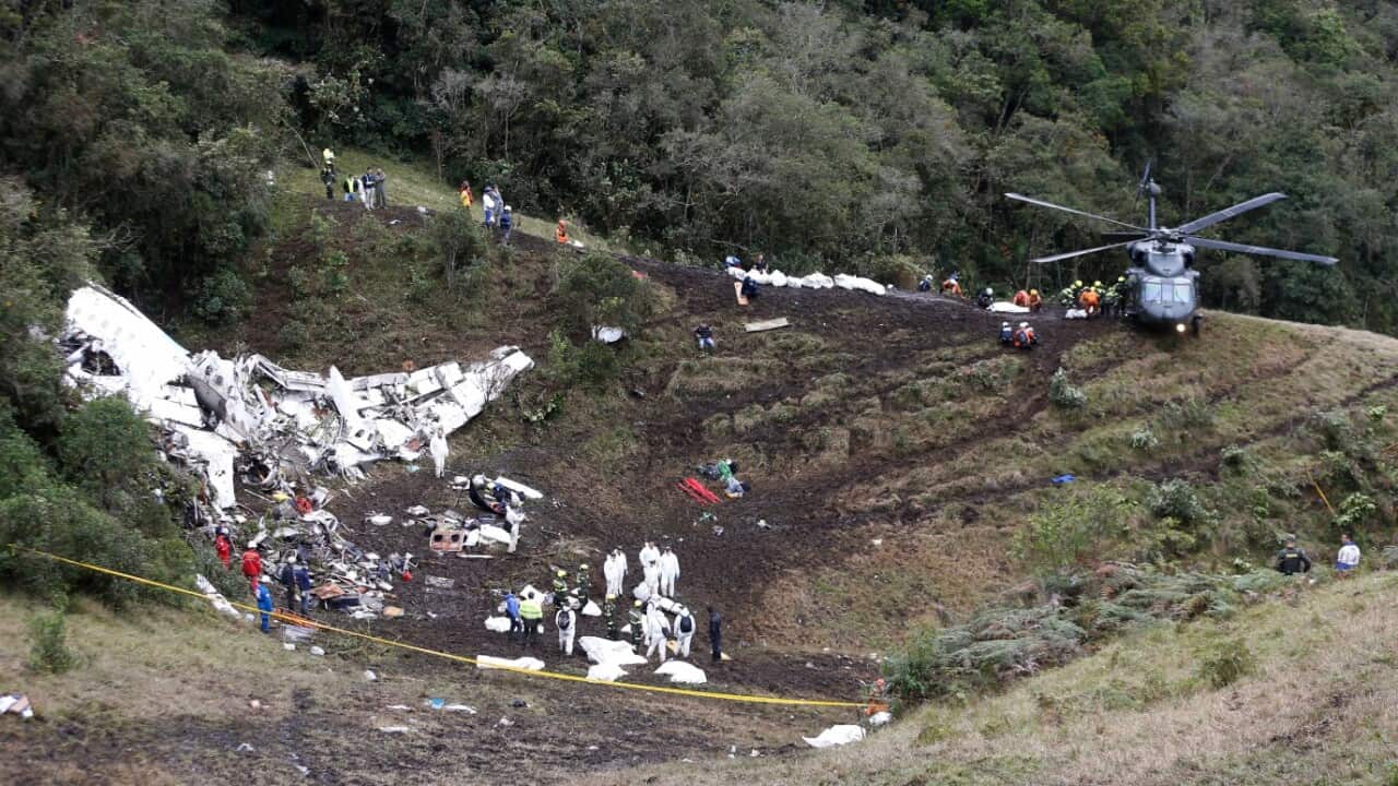 Rescue workers arrange for evacuation of the bodies of victims of an airplane that crashed in La Union, a mountainous area near Medellin, Colombia