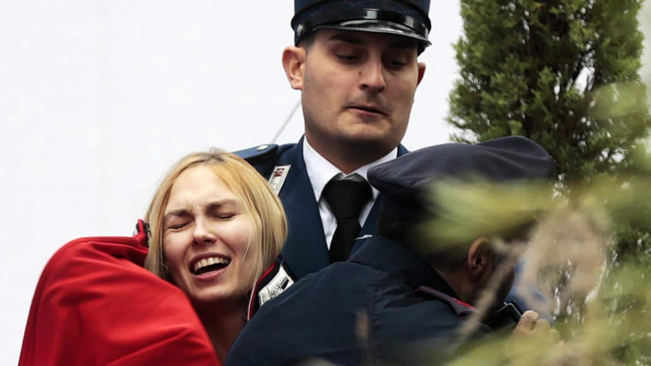 Vatican Gendarmes stop a member of Femen