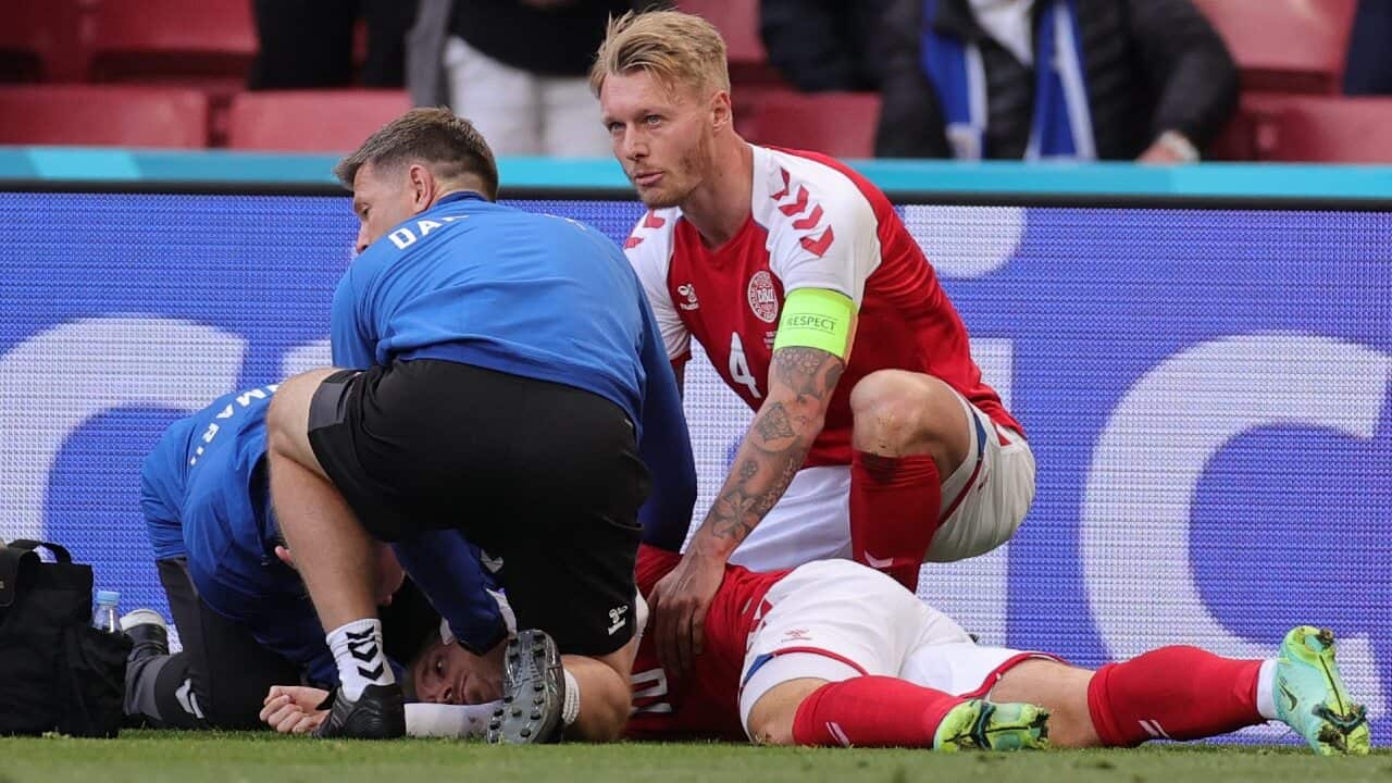 Christian Eriksen receives medical treatment after collapsing during a Denmark match