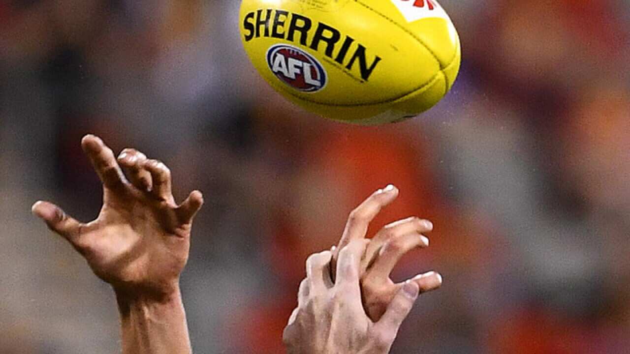 Generic picture of hands competing for the ball during an AFL match