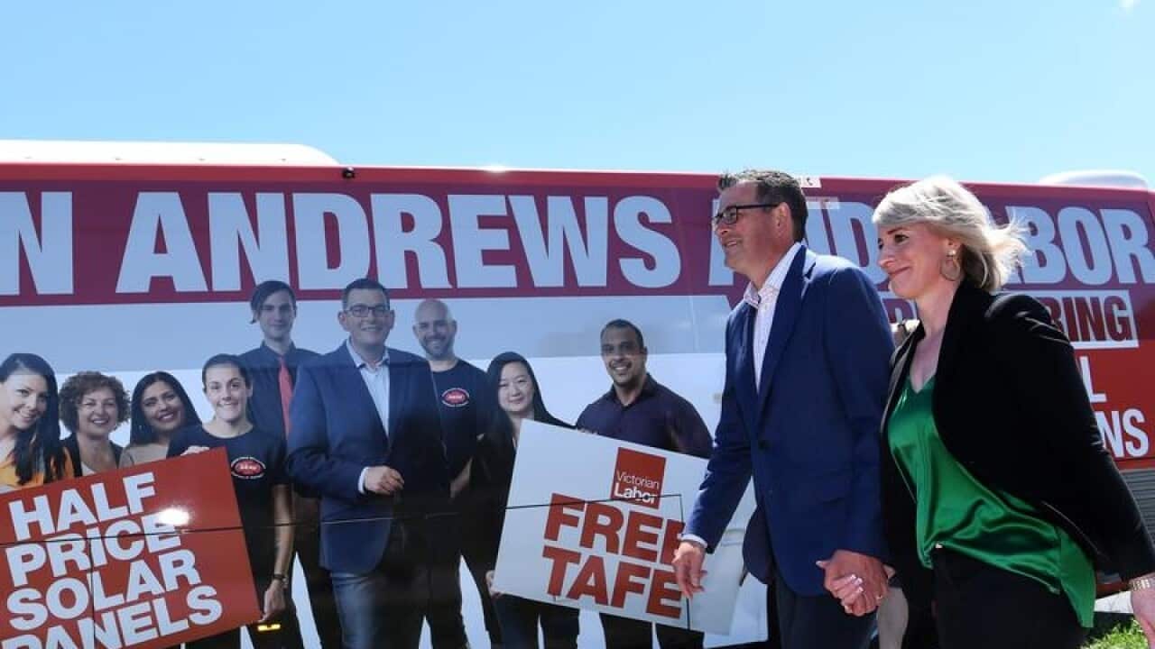 Victorian Premier Dan Andrews and wife Cath in front of a Labor bus.
