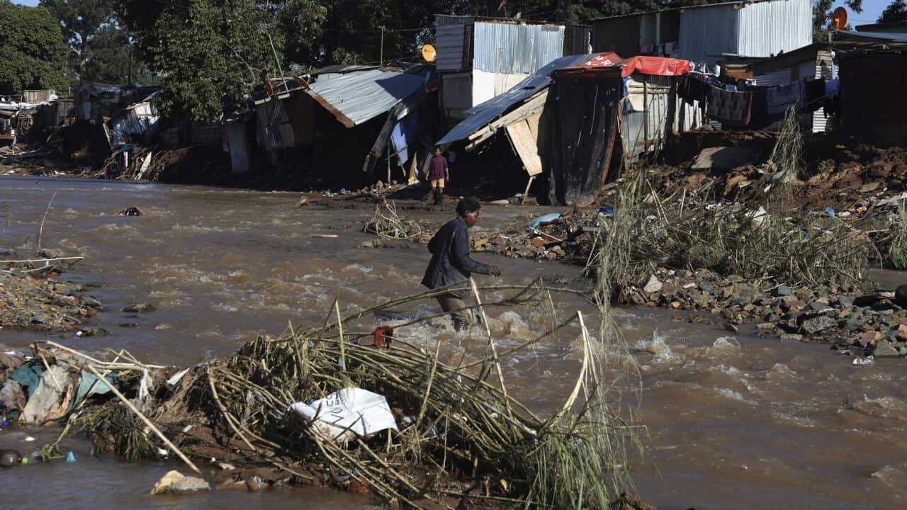 A man crosses the river in Durban, South Africa (AAP).jpg