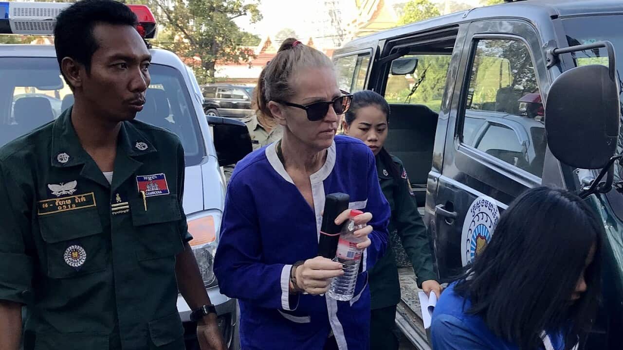 Australian national Tammy Davis-Charles is escorted by Cambodian prison guard to court.