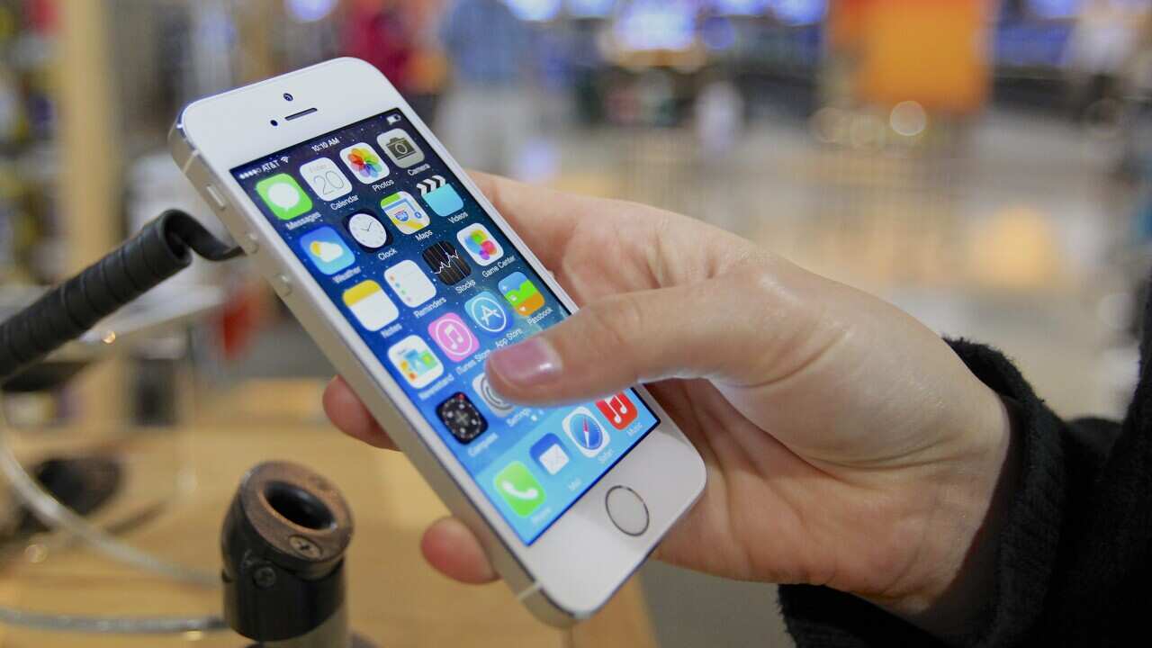 A customer examines an iPhone 5s