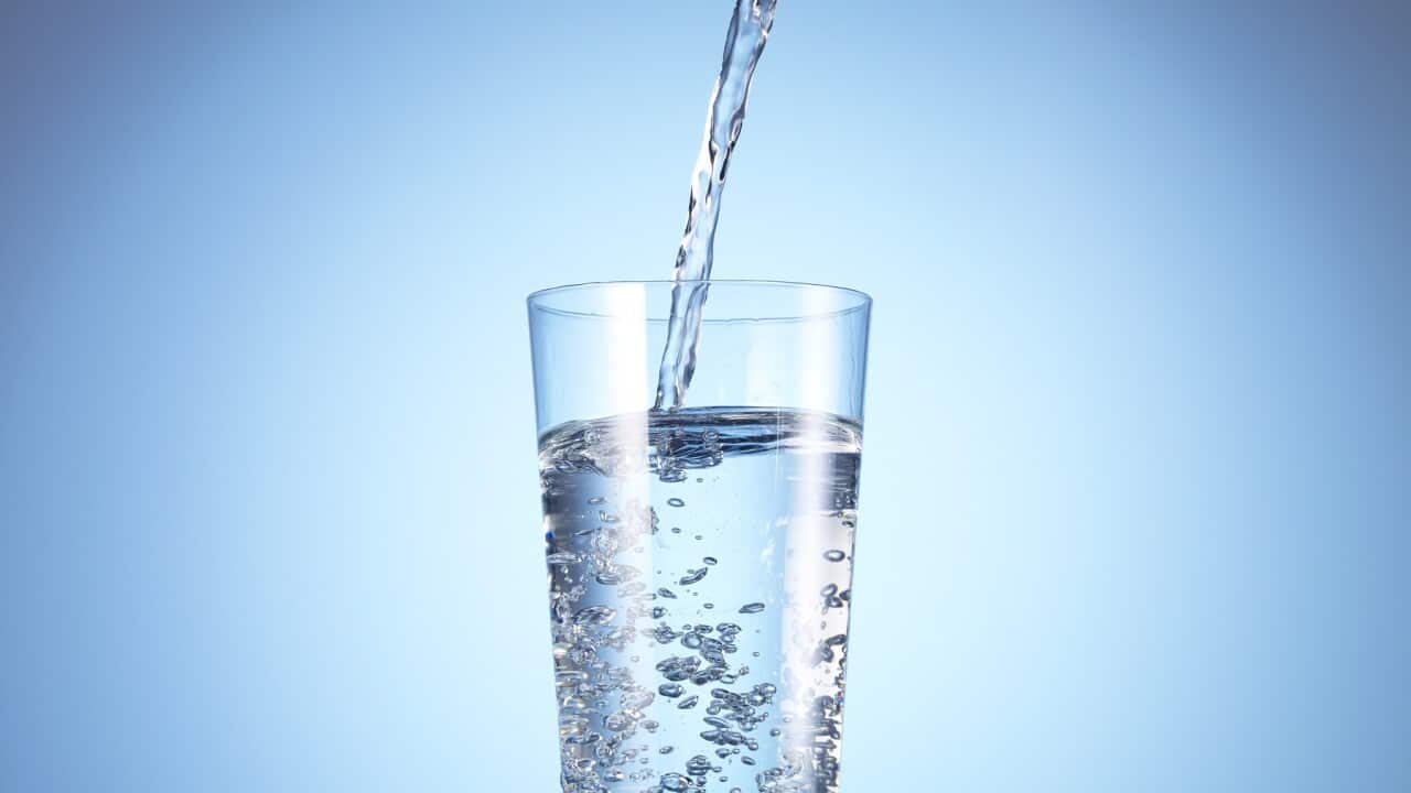 Cold drink water being poured into glass