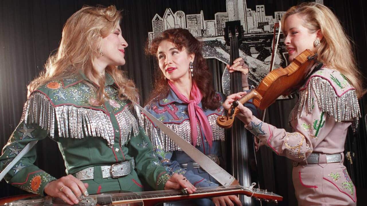 Three women play musical instruments.