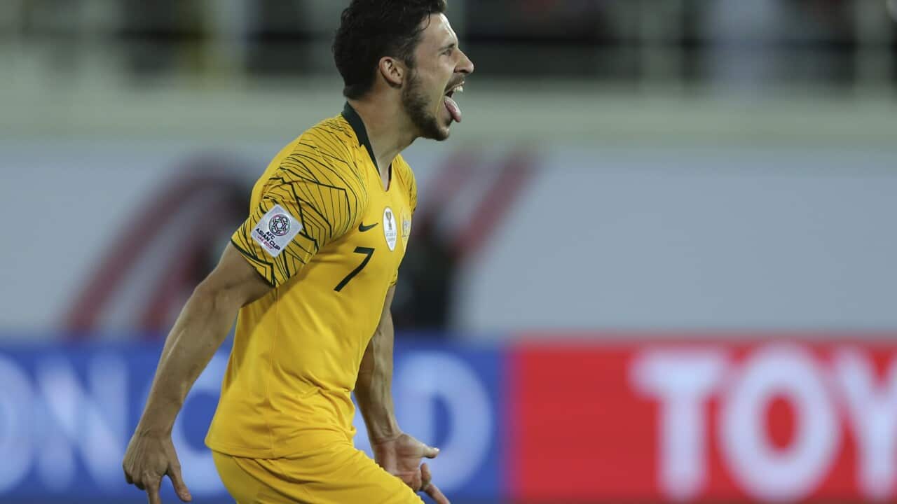Australia's forward Mathew Leckie celebrates after scoring the winning penalty in a shootout at the end of the AFC Asian Cup round of 16 soccer match between Australia and Uzbekistan