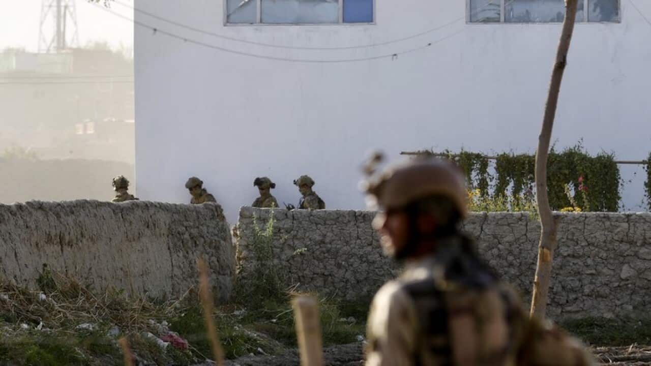fghan security officials secure the scene after six rockets were fired near Kabul airport following the arrival of US Defense Secretary General James Mattis