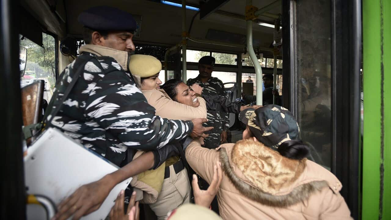 Police detain a protester during a demonstration against the Citizenship Amendment Act (CAA), outside Assam Bhawan.