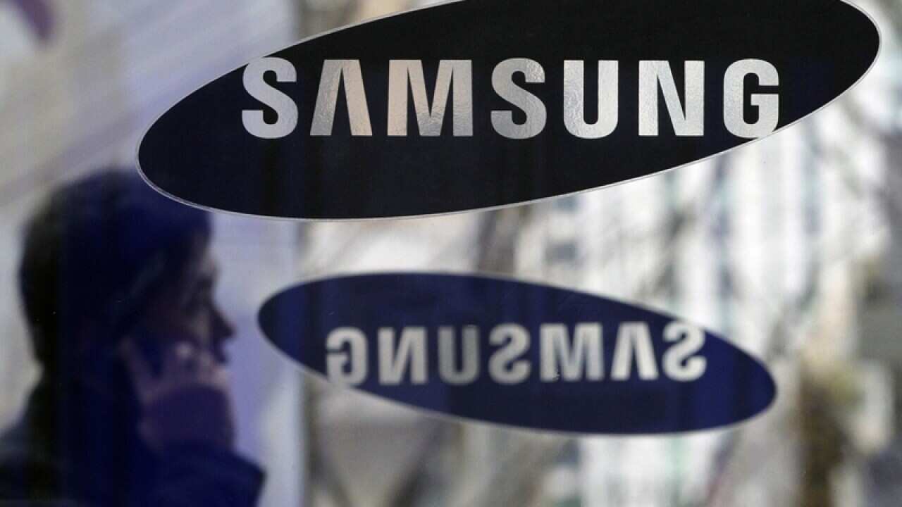 A man passes by a Samsung Electronics logo in Seoul