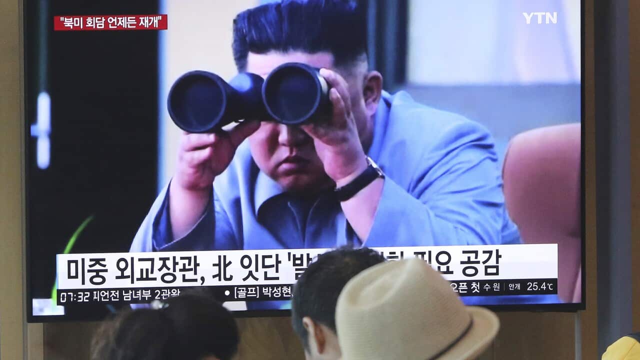 A file photo of people at a Seoul train station watching a TV showing footage of North Korean leader Kim Jong Un.