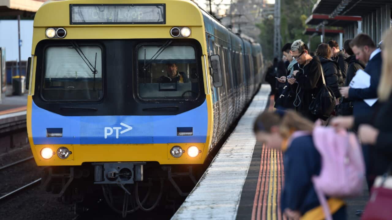 Peak hour commuters wait for a city loop train at Newmarket Station