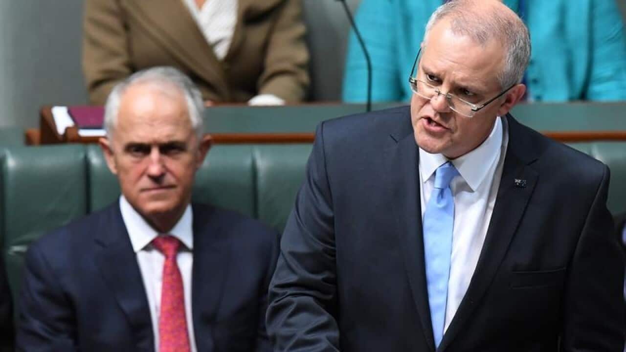 Malcolm Turnbull watches Scott Morrison hand down the budget.