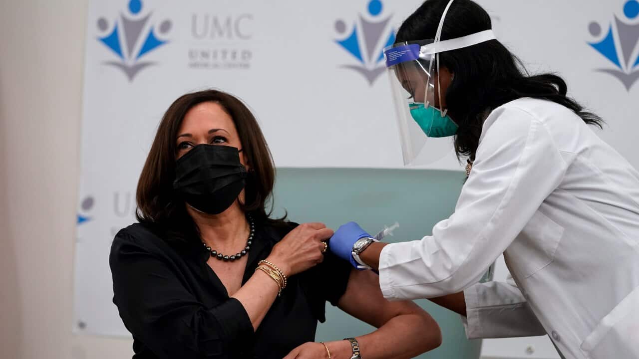 Vice President-elect Kamala Harris receives the Moderna COVID-19 vaccine from nurse Patricia Cummings.