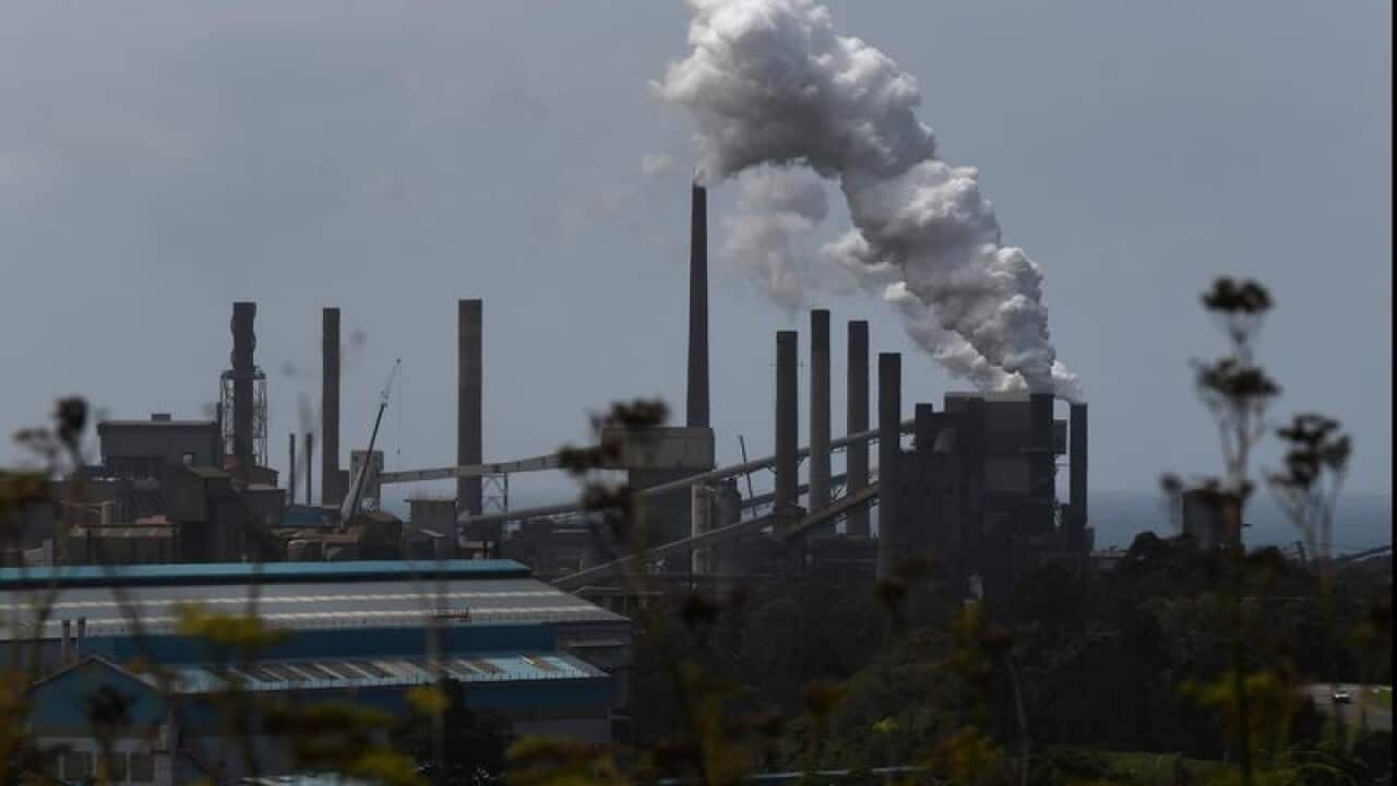 The Port Kembla Steelworks from a distance, smokestacks billowing
