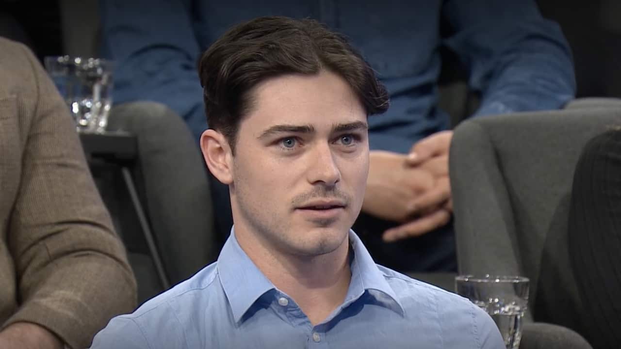 Man in sitting in a studio.