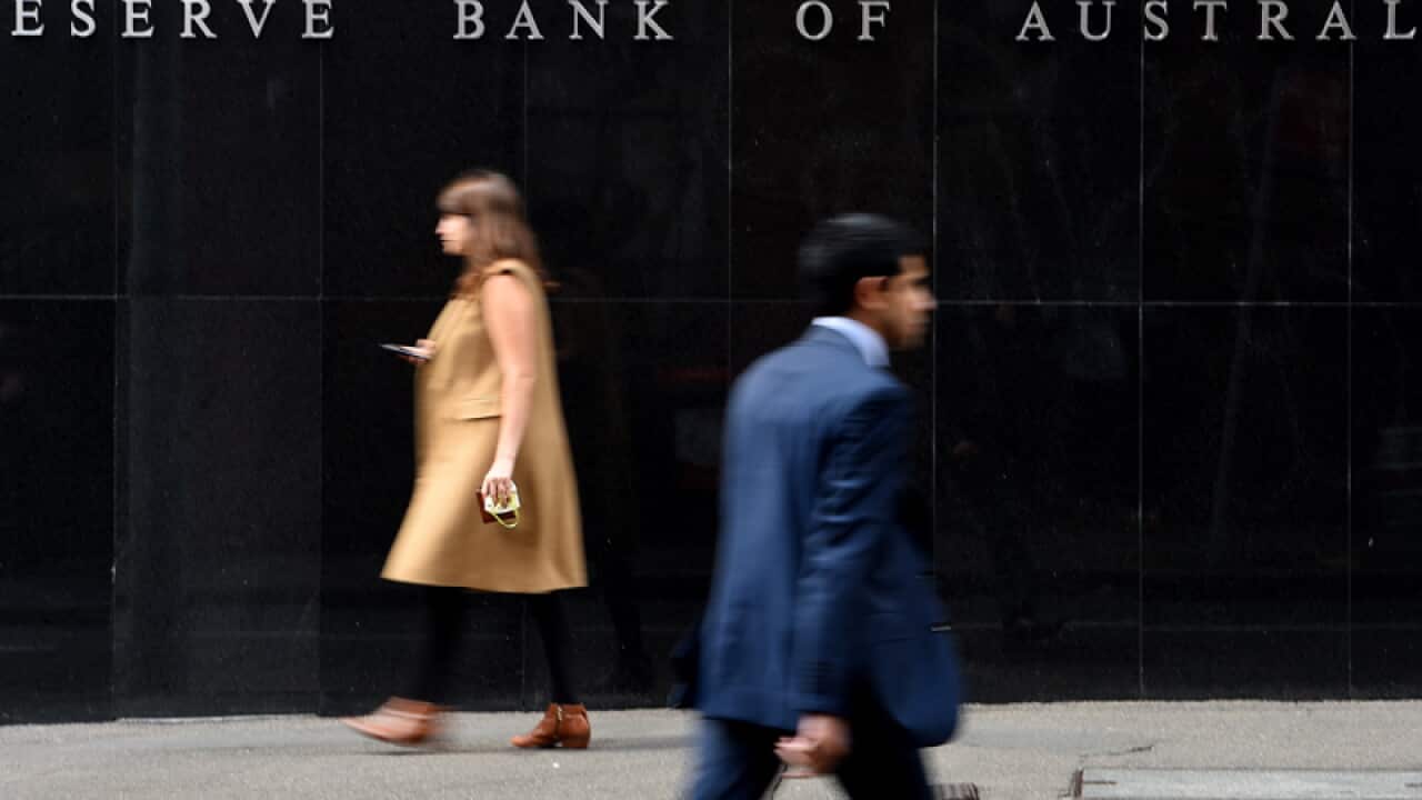 Pedestrians are seen walking past the Reserve Bank of Australia (RBA) in Sydney