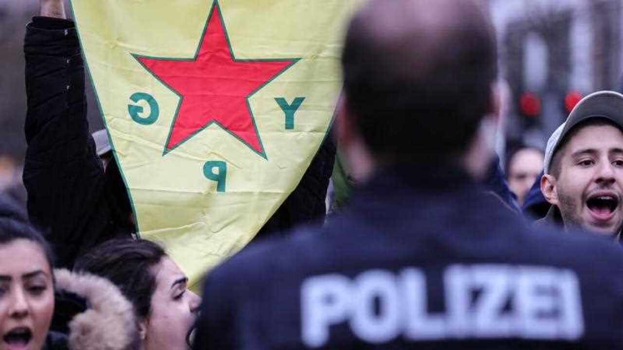 Supporters of the Kurdish Popular Protection Units (YPG) shout to protest against a rally in support of Turkish government's military operation named 'Operation Olive Branch' in Frankfurt Main, Germany, 24 January 2018.