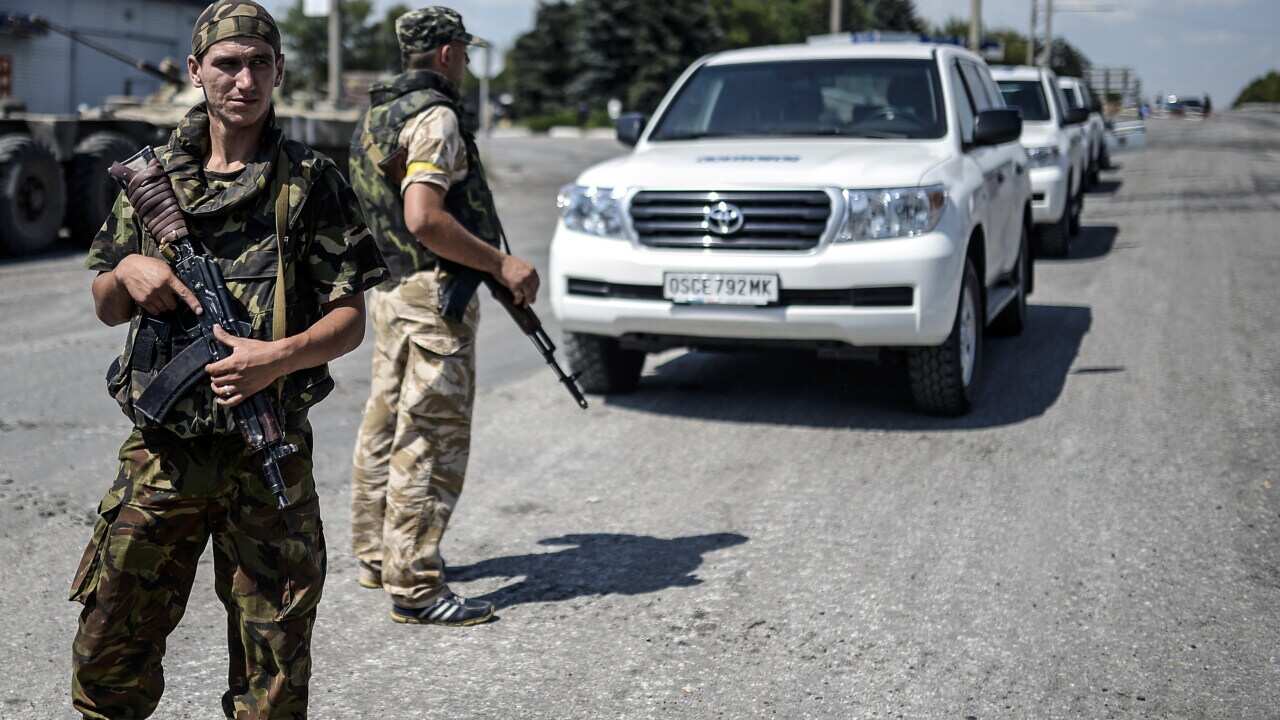 Ukrainian soldiers on guard near the convoy of the OSCE (the Organisation for Security and Cooperation in Europe) getty.jpg