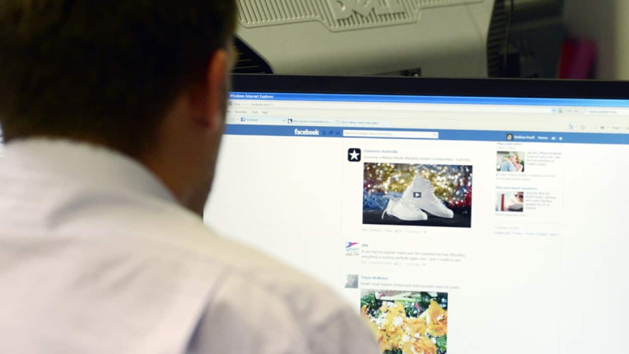 A man uses a desktop computer