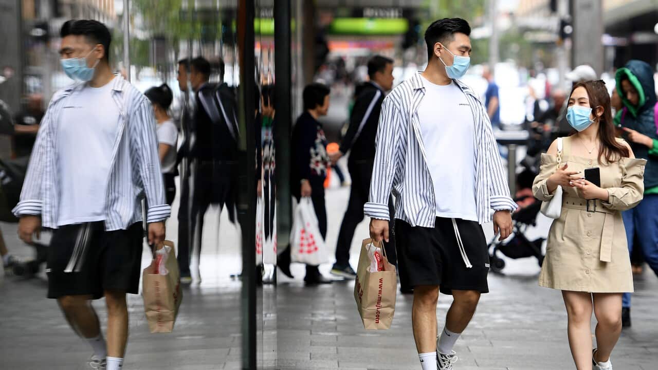 A ouple wearing face masks