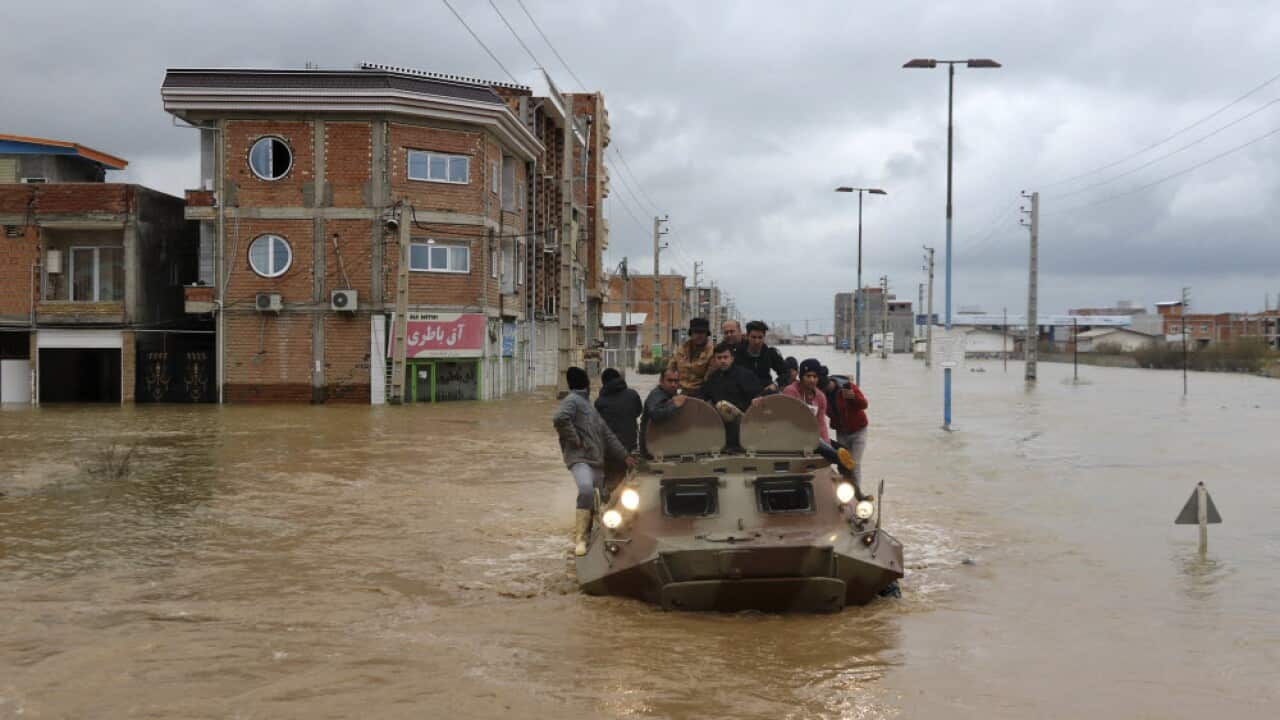 Military vehicles rescue people after flash flooding around the northern city of Aq Qala in Golestan province, Iran.
