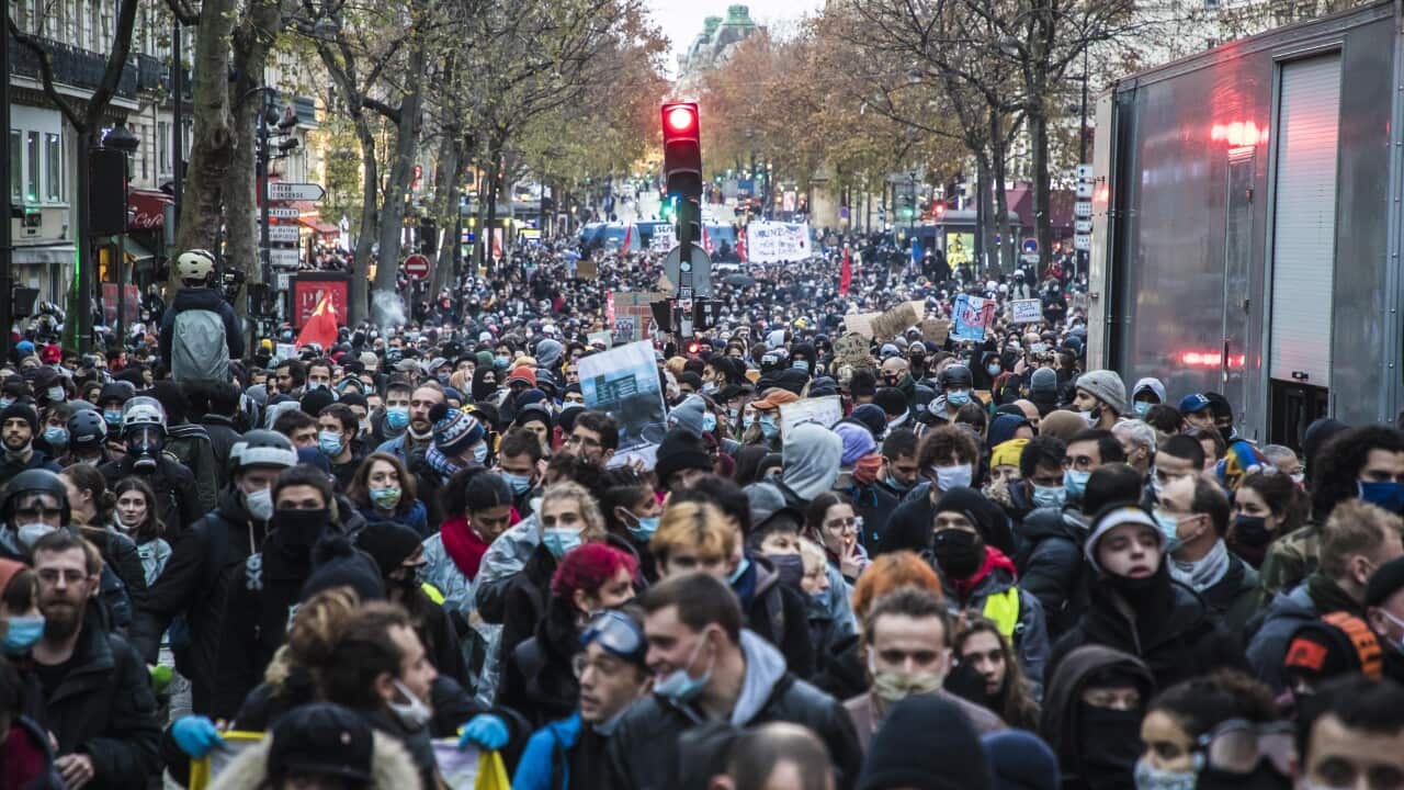 Protesters demonstrate against France's controversial global security law, in Paris, France, 12 December 2020.
