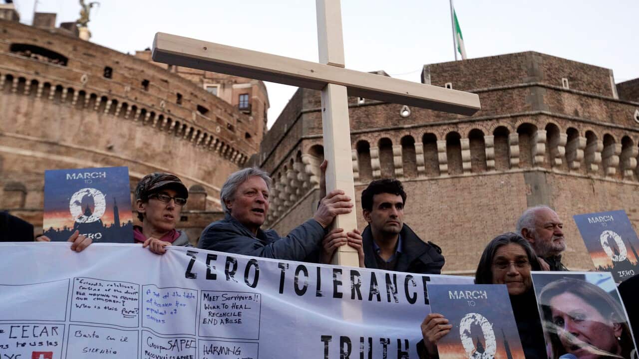 Survivors of sex abuse hold a cross as they gather during a vigil prayer of the victims of sex abuse near Castle Sant' Angelo in Rome.