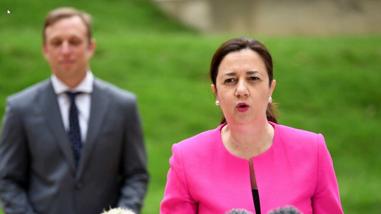 Queensland Premier Annastacia Palaszczuk, flanked by Deputy Premier and Health Minister Steven Miles. 