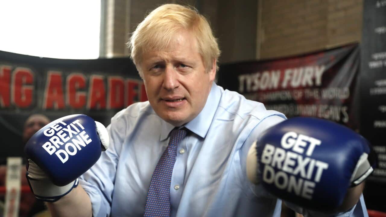 Britain's Prime Minister Boris Johnson poses for a photo wearing boxing gloves during a stop in his General Election Campaign trail.
