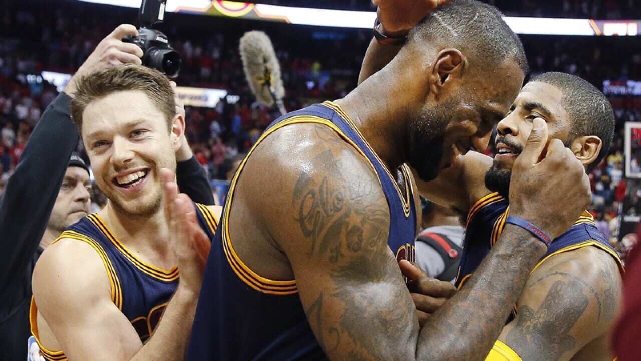 Cleveland Cavaliers' LeBron James (23) celebrates with teammates