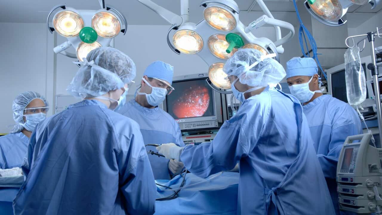 Surgeons operating on patient