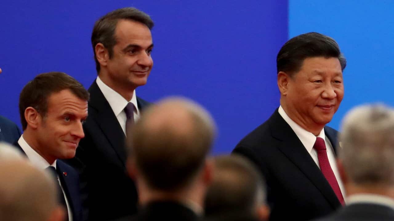 Xi Jinping walks in with Kyriakos Mitsotakis, as they arrive for the opening ceremony of the China International Import Expo in Shanghai