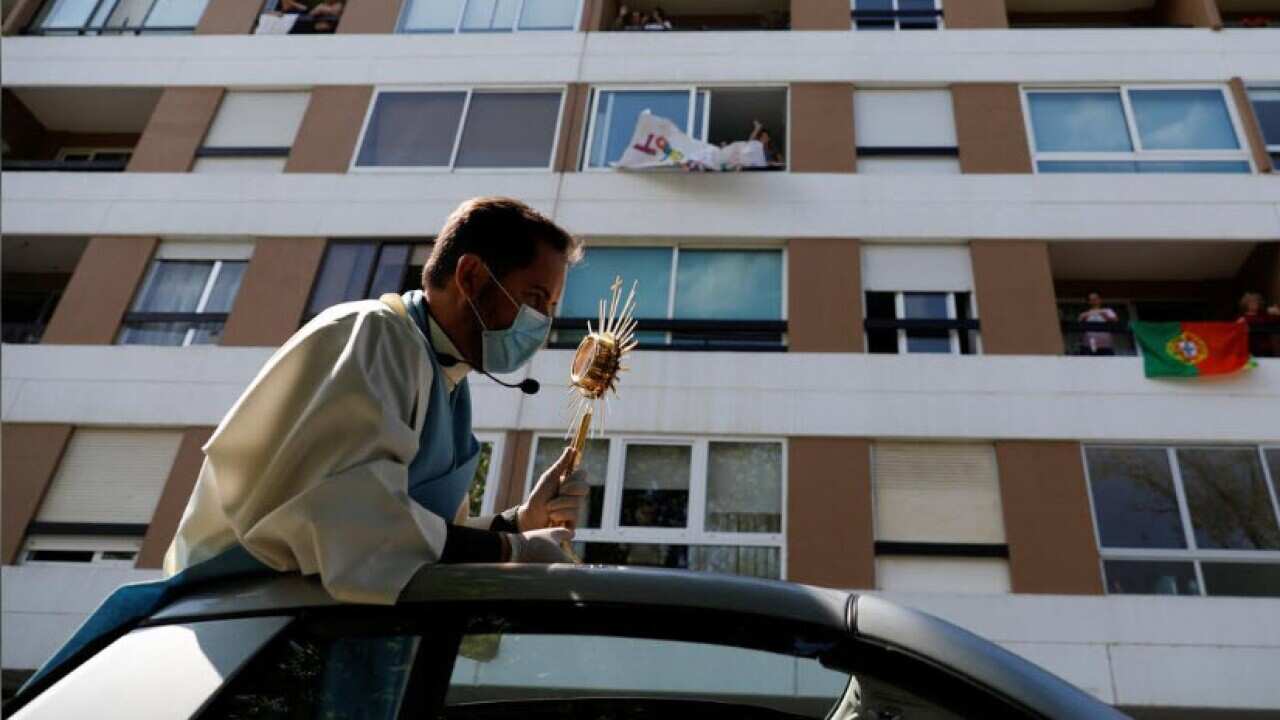 Priest Nuno Westwood holds a tour for the Portuguese neighborhoods of Oeiras to bless for Easter Sunday.