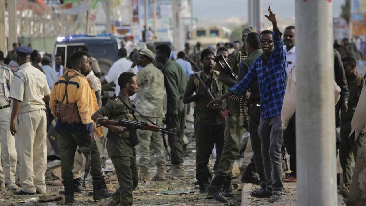 Security forces gather at the scene following a suicide