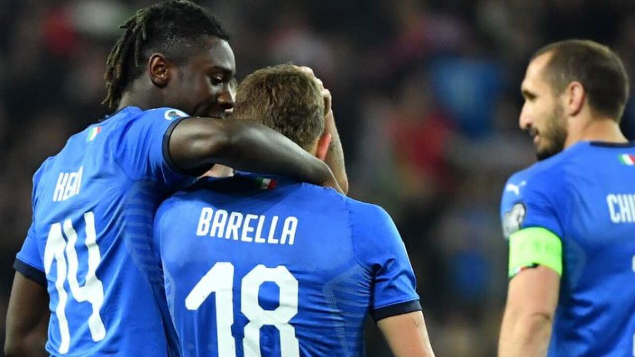 Italy's midfielder Nicolo Barella celebrates with Italy's forward Moise Kean after scoring during the Euro 2020 football match between Italy and Finland.