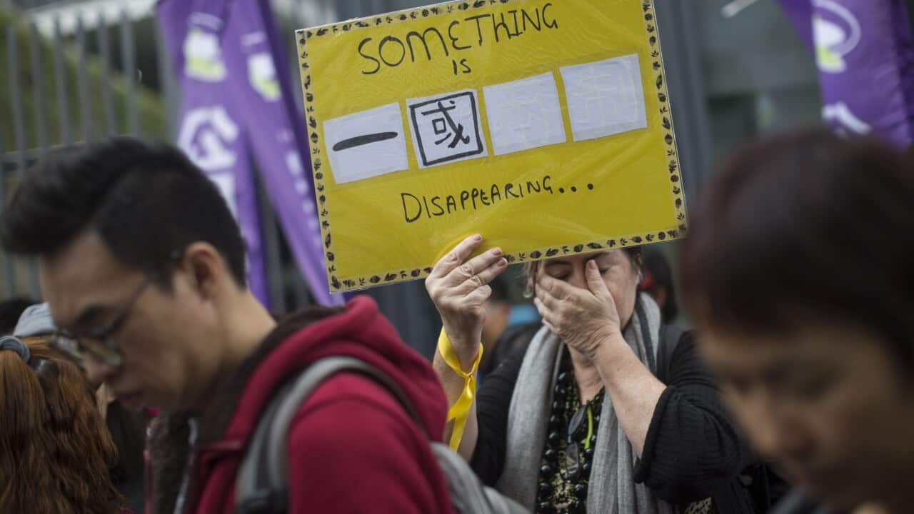 A participant holds a sign in Chinese reading: 'One Country' with two white squares for the missing 'Two Systems' during a protest in Hong Kong, China, 10 January 2016. (EPA/JEROME FAVRE)