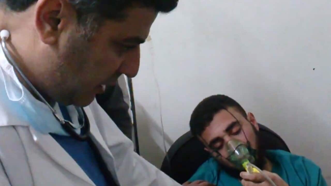 A Syrian man receives oxygen from a medic