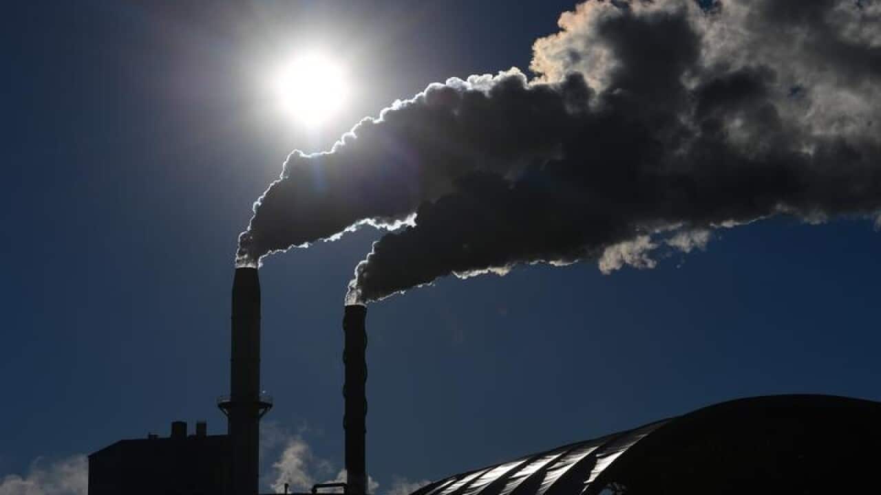 two smoke stacks releasing emissions.