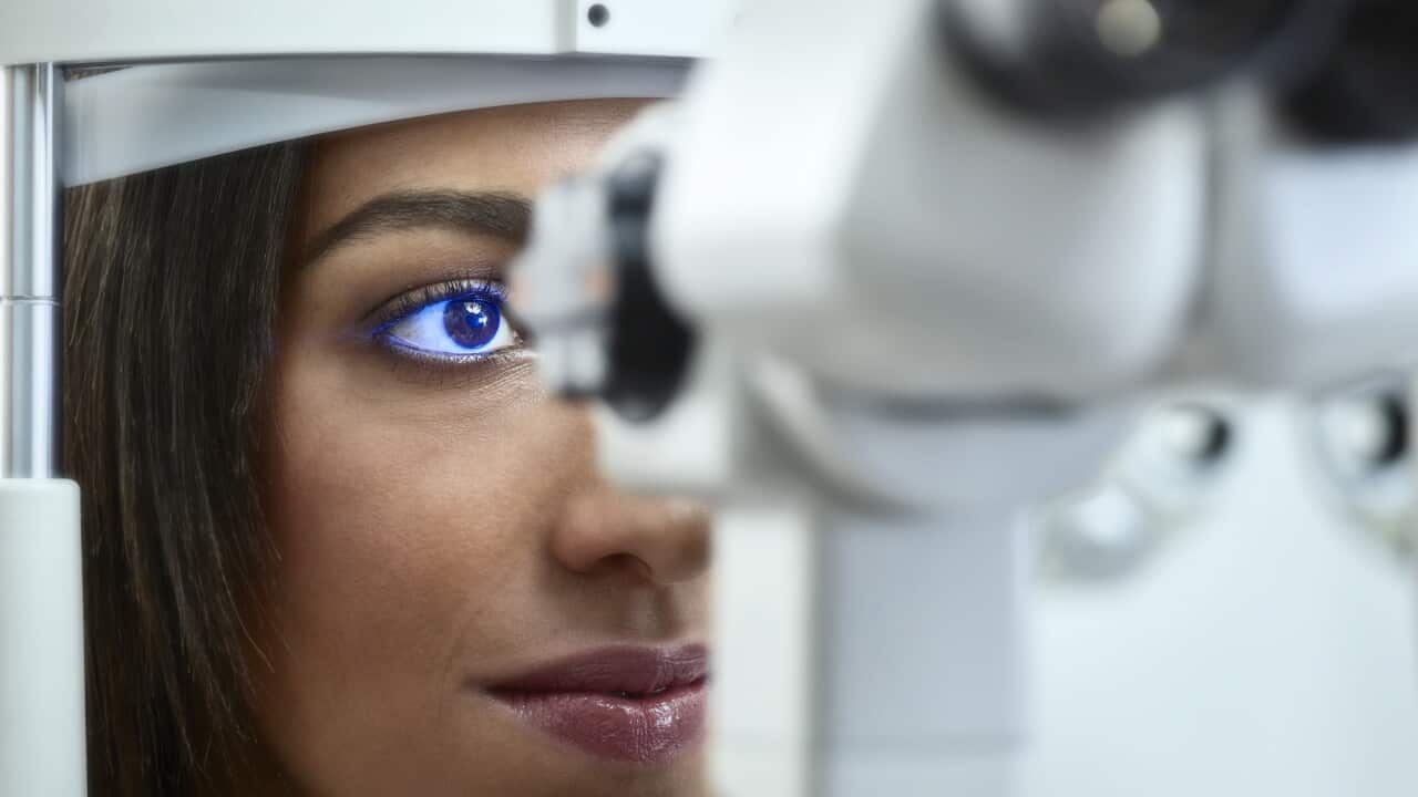 Optician, Young woman during eye test