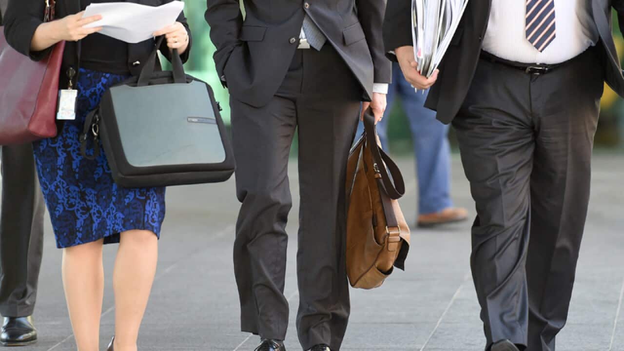 Office workers walk through central Brisbane
